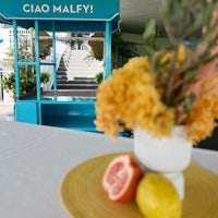 a table with a vase of lemons on it